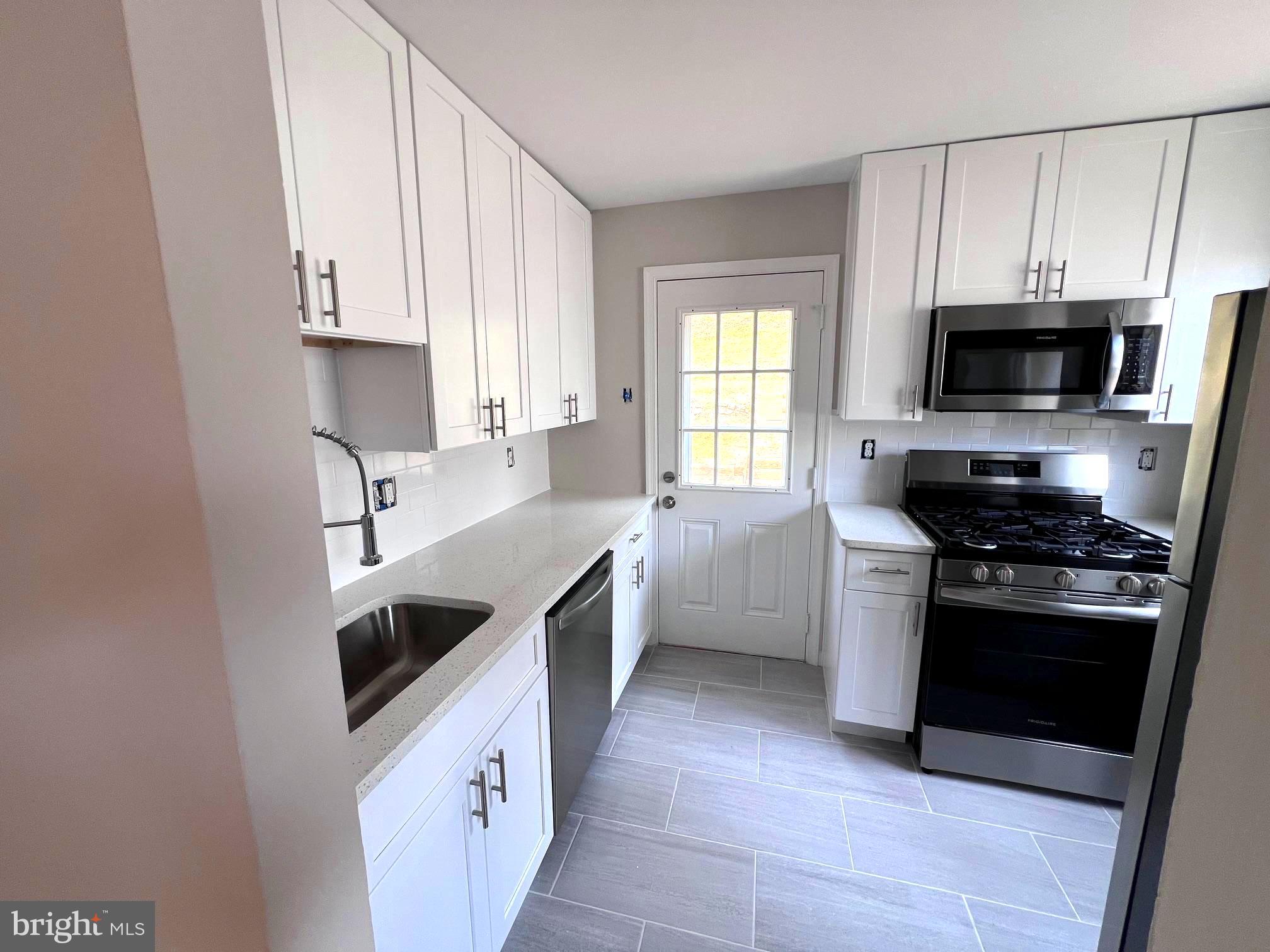 708 Crabb Avenue Rockville, MD 20850 - Photo 4 of 24 a kitchen with a sink stove and microwave