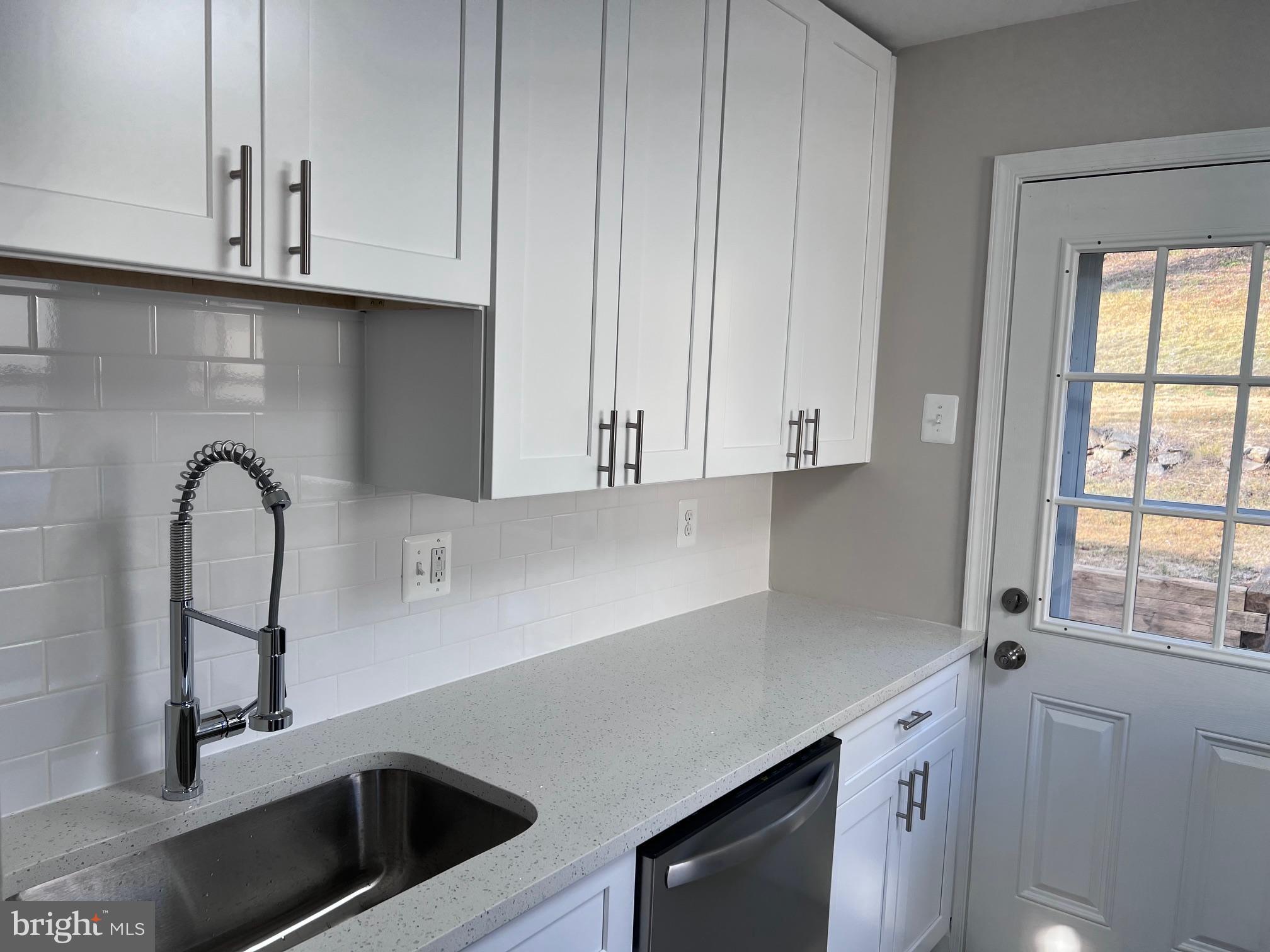 708 Crabb Avenue Rockville, MD 20850 - Photo 5 of 24 a kitchen with stainless steel appliances a sink a stove and white cabinets