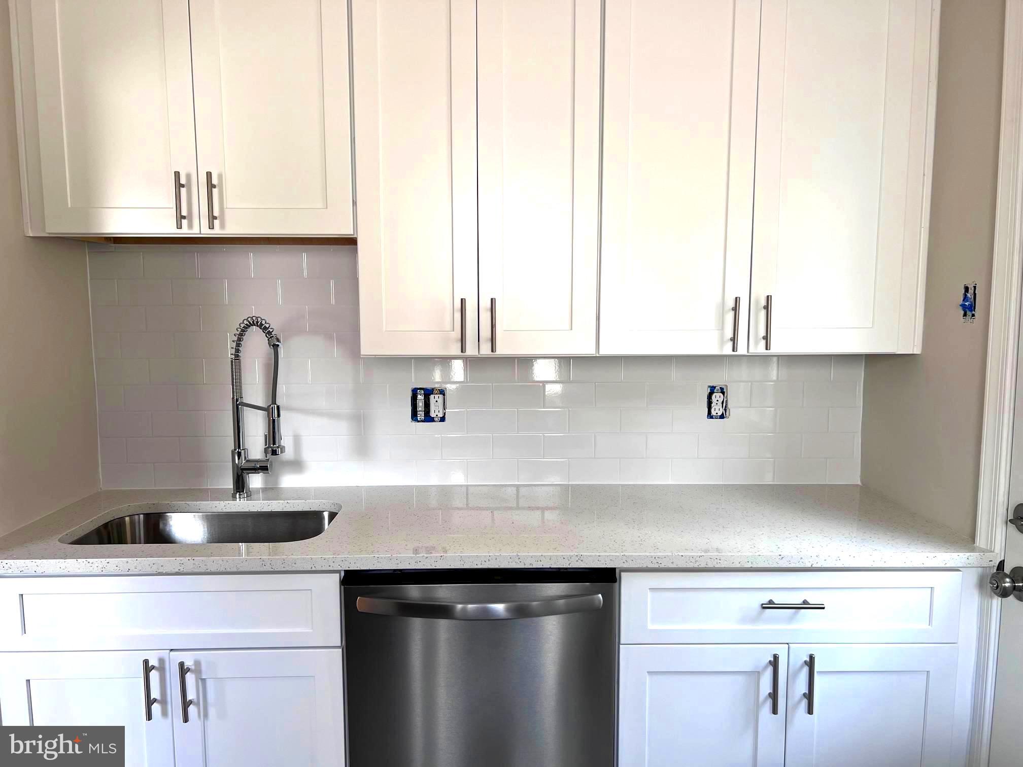 708 Crabb Avenue Rockville, MD 20850 - Photo 7 of 24 a kitchen with appliances a sink and cabinets