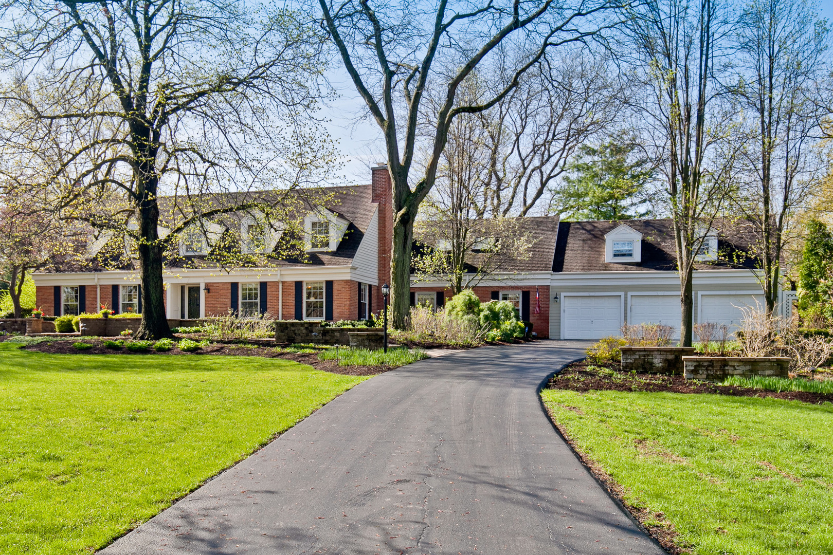 1991 Pheasant Trail Inverness, IL 60067 - Photo 2 of 53 a front view of a house with a yard table and chairs