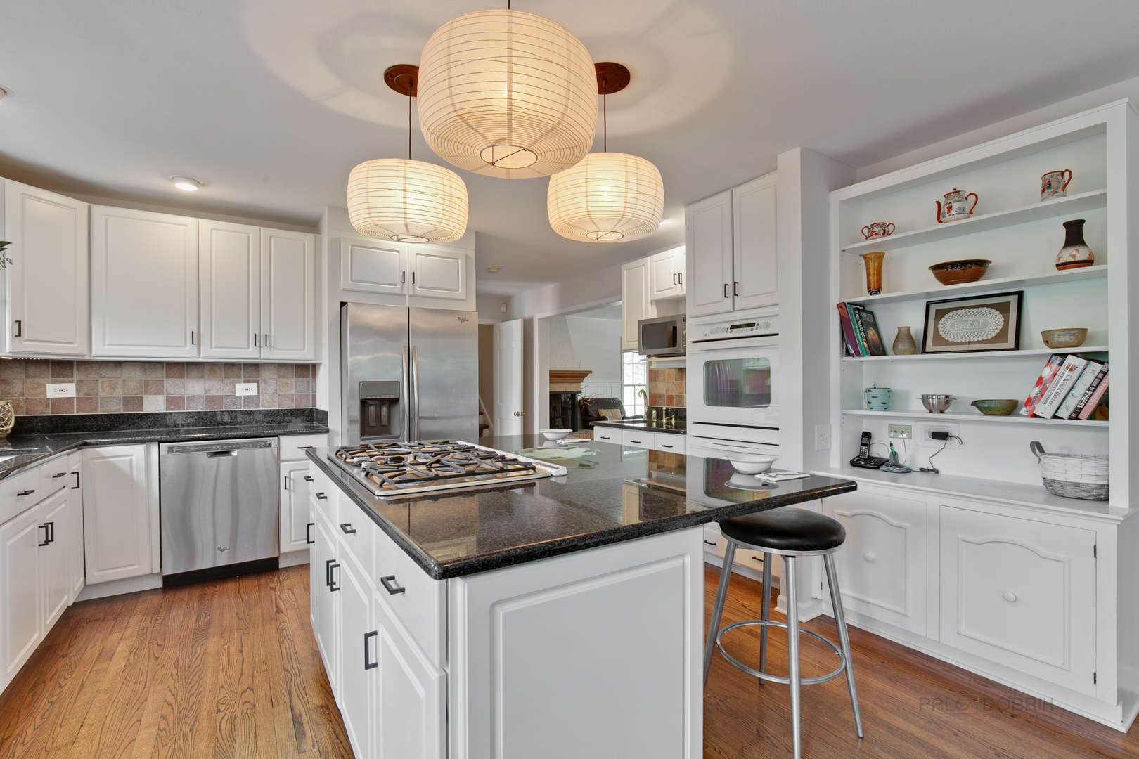 1991 Pheasant Trail Inverness, IL 60067 - Photo 19 of 53 a kitchen with stainless steel appliances granite countertop a stove a sink dishwasher and white cabinets with wooden floor