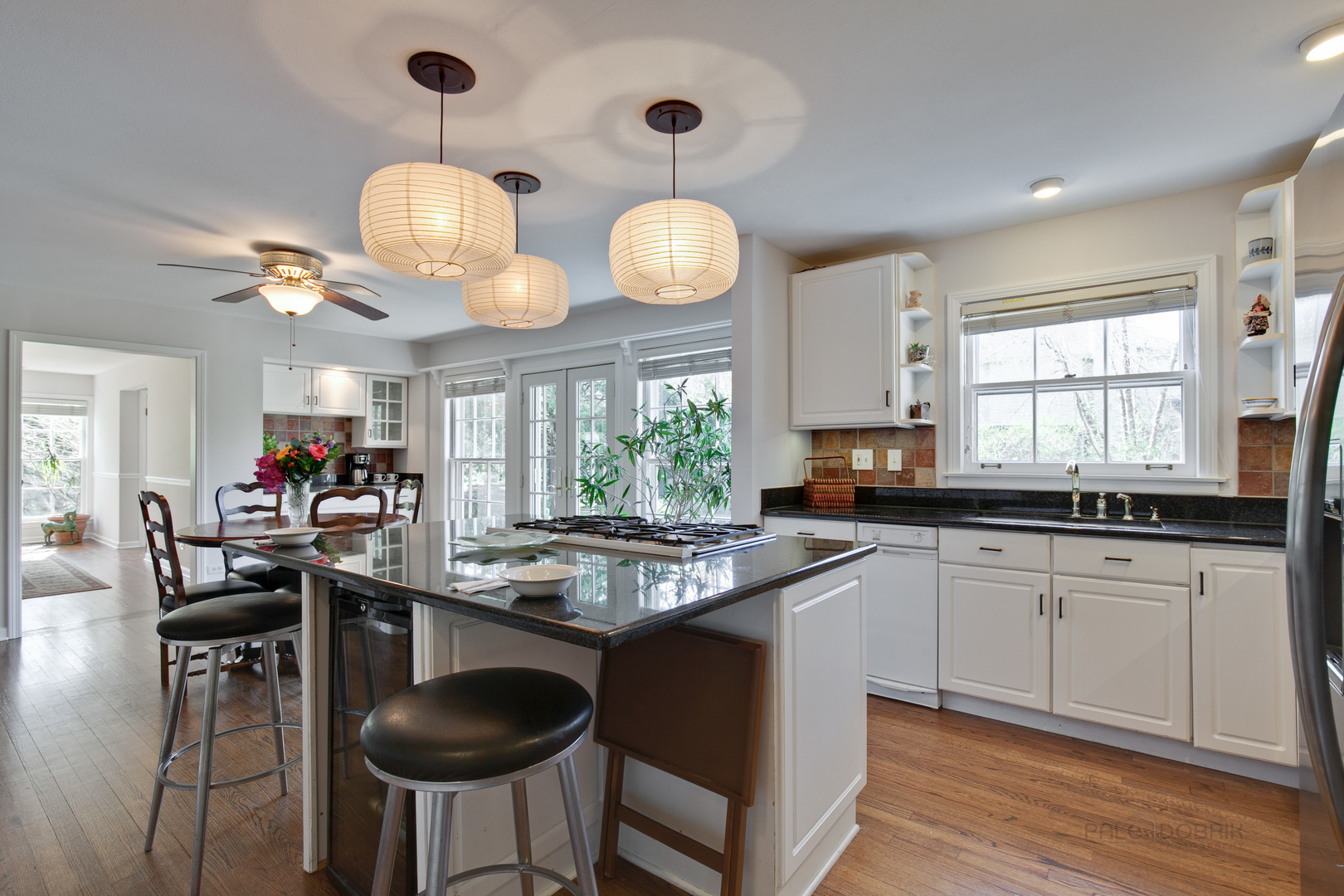 1991 Pheasant Trail Inverness, IL 60067 - Photo 21 of 53 a kitchen with stainless steel appliances granite countertop a stove a sink dishwasher a dining table and chairs with wooden floor