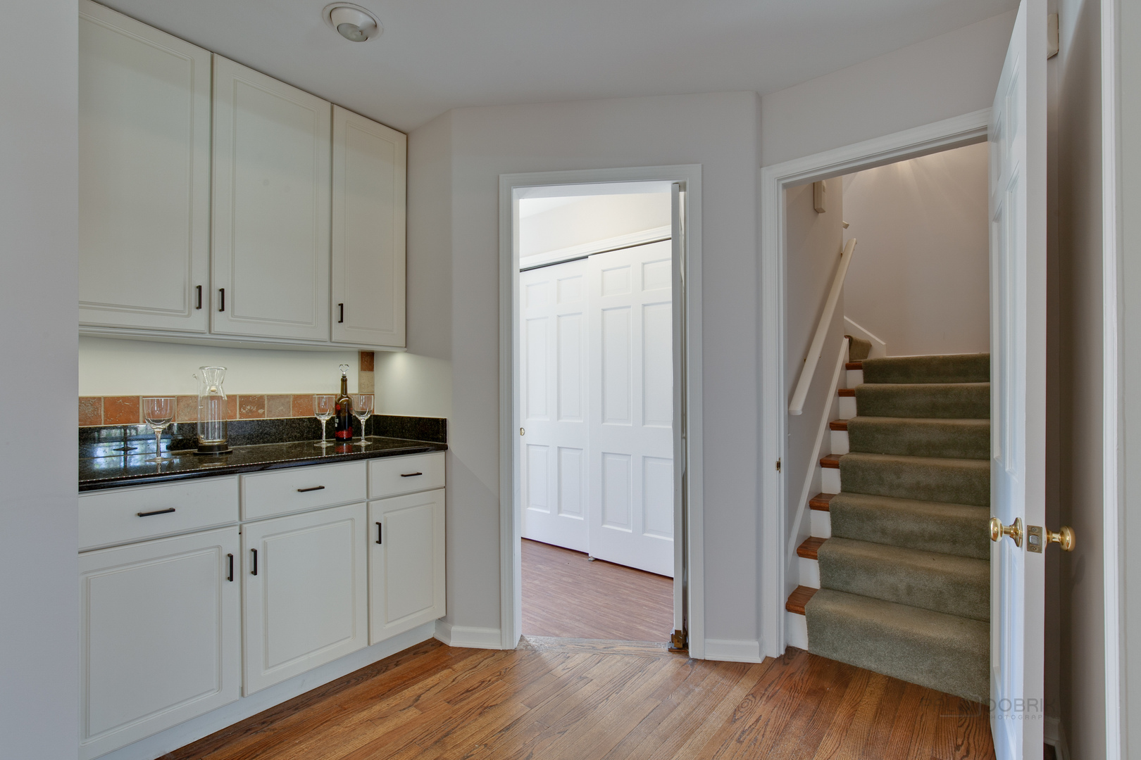 1991 Pheasant Trail Inverness, IL 60067 - Photo 22 of 53 a kitchen with white cabinets and wooden floor