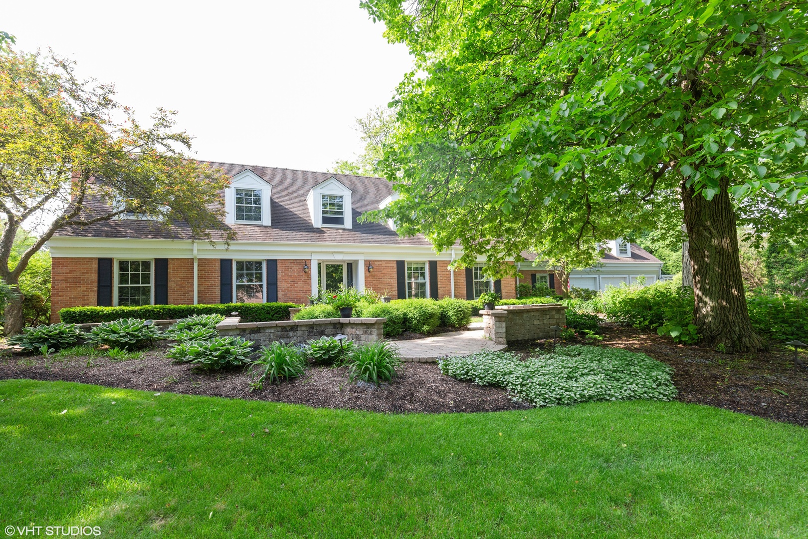1991 Pheasant Trail Inverness, IL 60067 - Photo 4 of 53 a front view of a house with a yard table and chairs