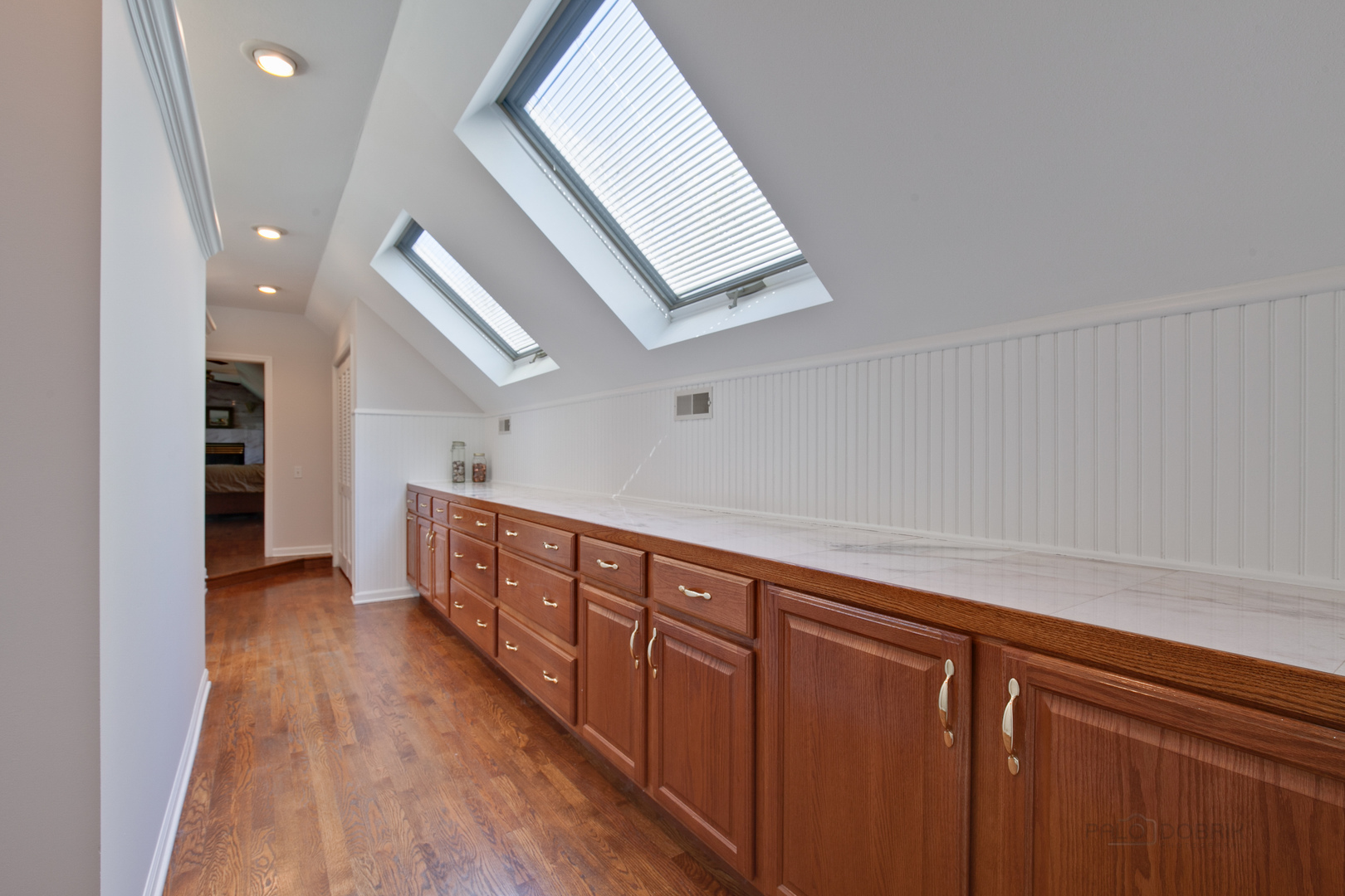 1991 Pheasant Trail Inverness, IL 60067 - Photo 32 of 53 a hallway with wooden cabinets and staircase