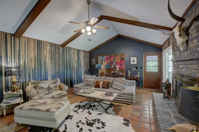 a living room with furniture a fireplace and a chandelier