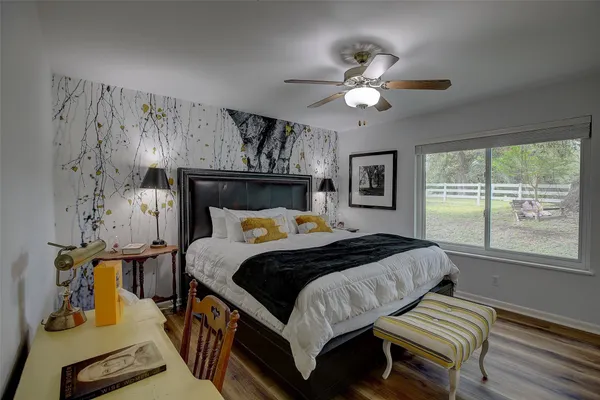 a bed sitting in a bedroom next to a window