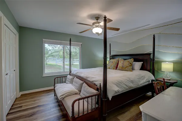a bedroom with bed and window