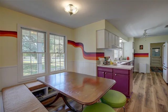 a kitchen with wooden cabinets a sink a stove and a window