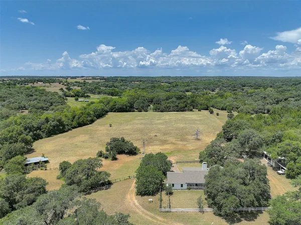 a view of a lake in middle of the green field and covered with green space