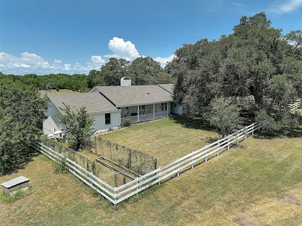 a view of a house with a backyard and a tub