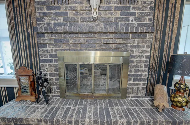 a view of a livingroom with wooden floor and a fireplace