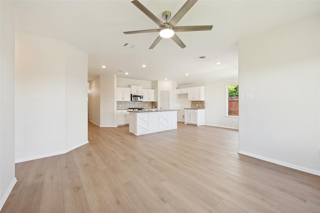 857 Watson Way Crowley, TX 76036 - Photo 3 of 25 Spacious open-concept living area featuring wood-finish flooring, recessed lighting, and a ceiling fan