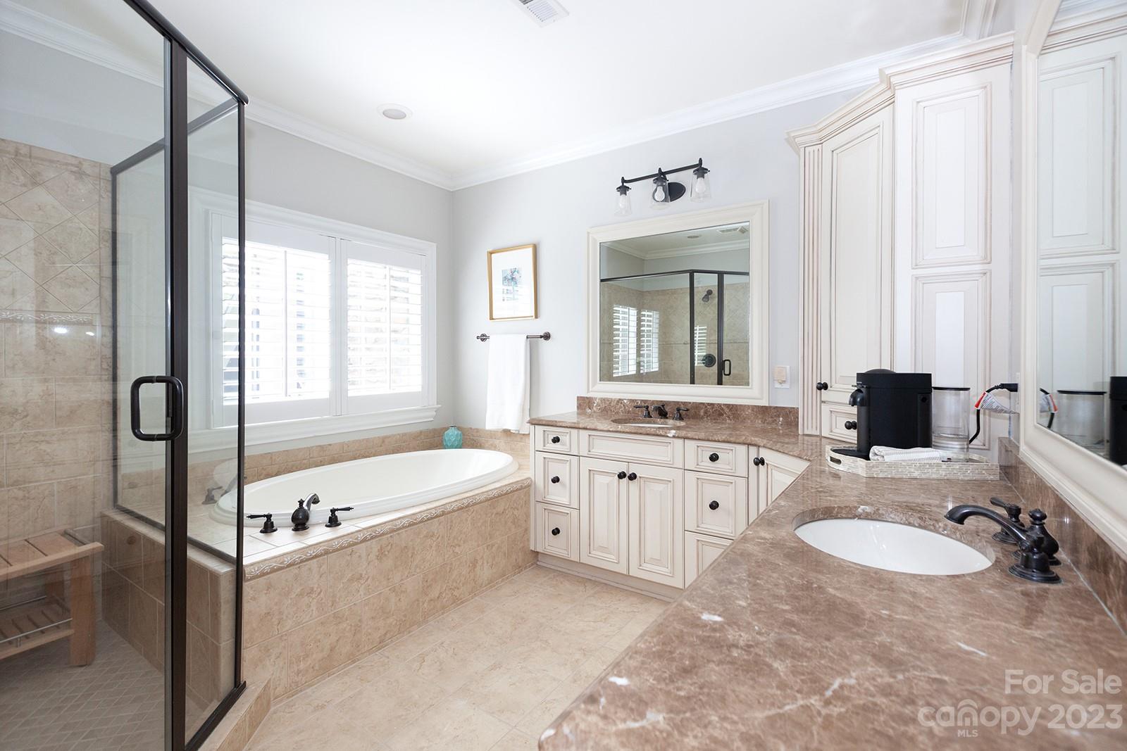 1925 Shoreham Drive Charlotte, NC 28211 - Photo 25 of 48 a spacious bathroom with a granite countertop tub sink and mirror
