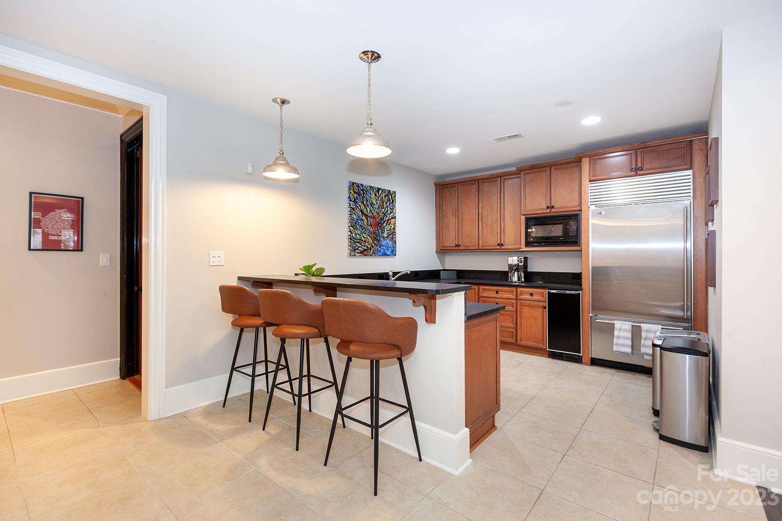 1925 Shoreham Drive Charlotte, NC 28211 - Photo 30 of 48 a kitchen with stainless steel appliances granite countertop a refrigerator a sink a stove and a cabinets