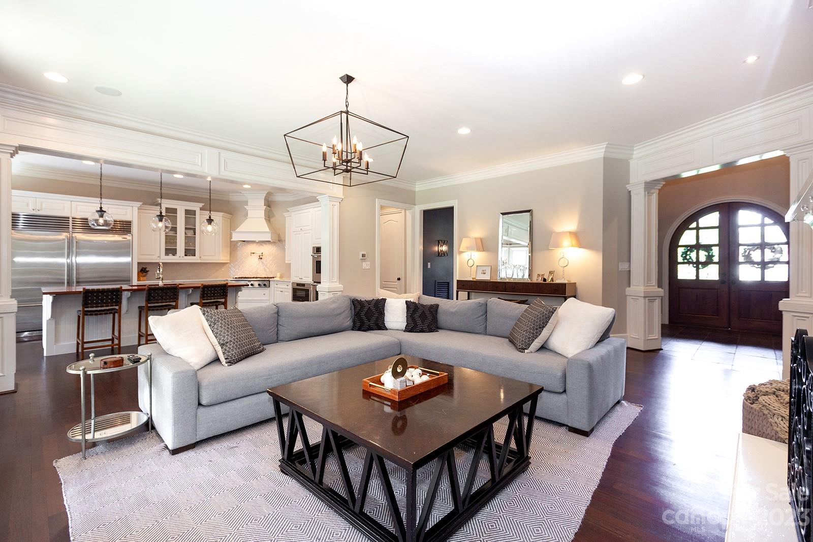 1925 Shoreham Drive Charlotte, NC 28211 - Photo 3 of 48 a living room with a couch and chandelier