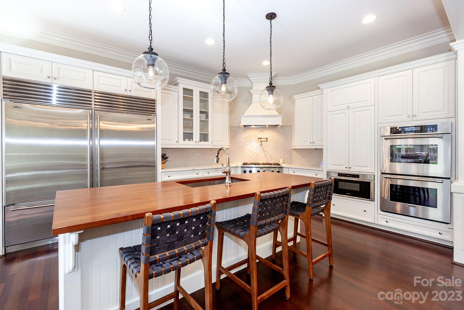 1925 Shoreham Drive Charlotte, NC 28211 - Photo 5 of 48 a kitchen with stainless steel appliances a dining table chairs and granite counter tops