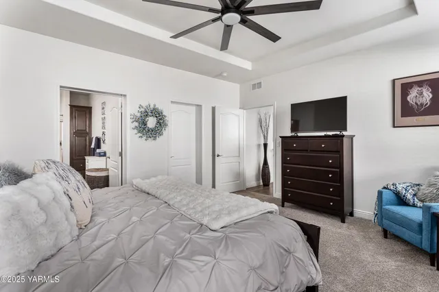 a bedroom with a bed and a television