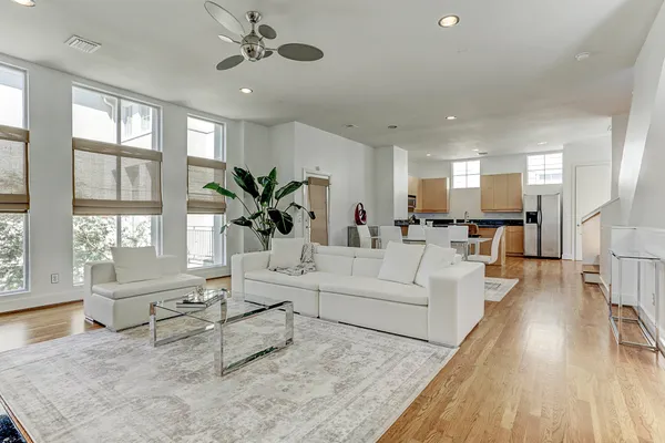 a living room with furniture and wooden floor