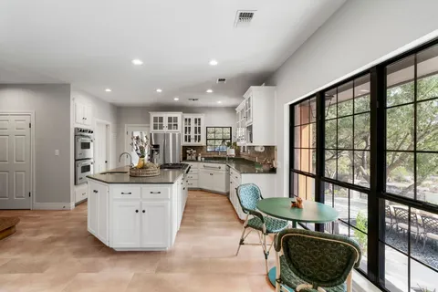 a living room with furniture a rug and a large window