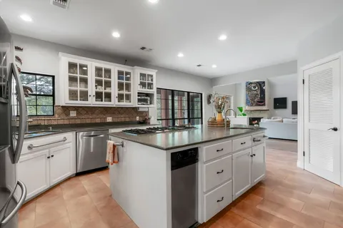 a kitchen with stainless steel appliances granite countertop a stove and a sink