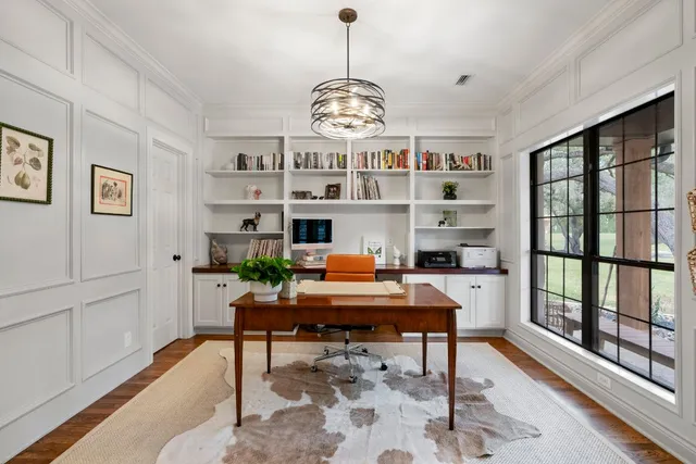 a view of a livingroom with furniture window and wooden floor
