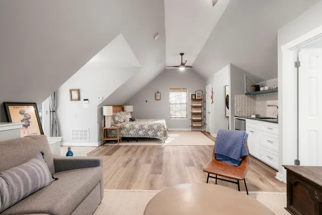 a bedroom with furniture and a wooden floor