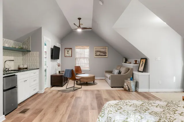 a living room with furniture window and wooden floor