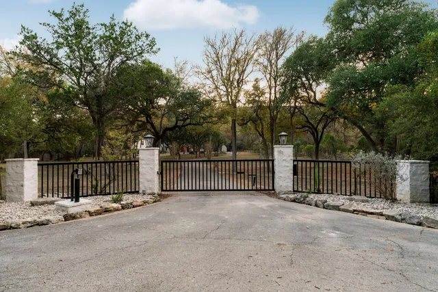 a view of a gate with wooden fence