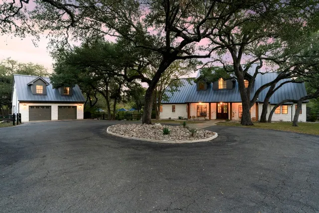 a view of a house with a yard and garage