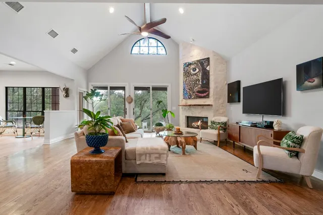 a living room with fireplace furniture and a flat screen tv