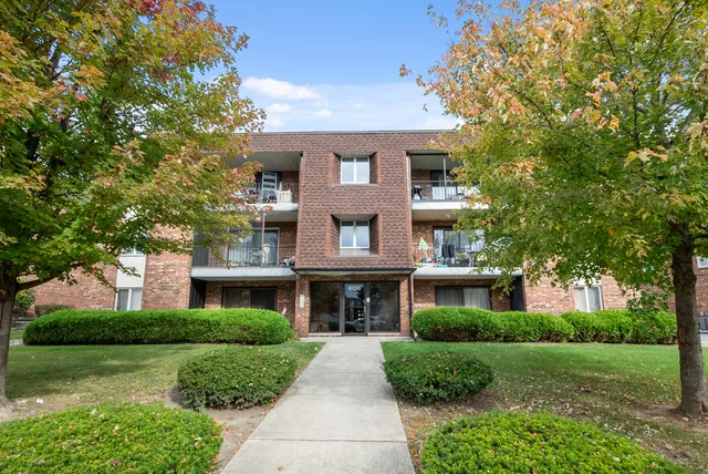 a front view of a brick house with a yard
