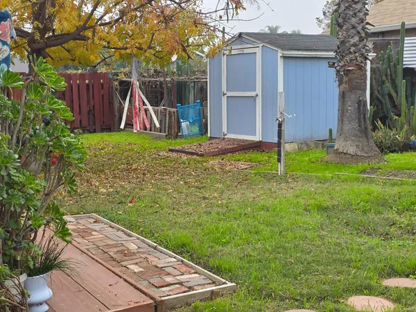 a view of a backyard with small cabin
