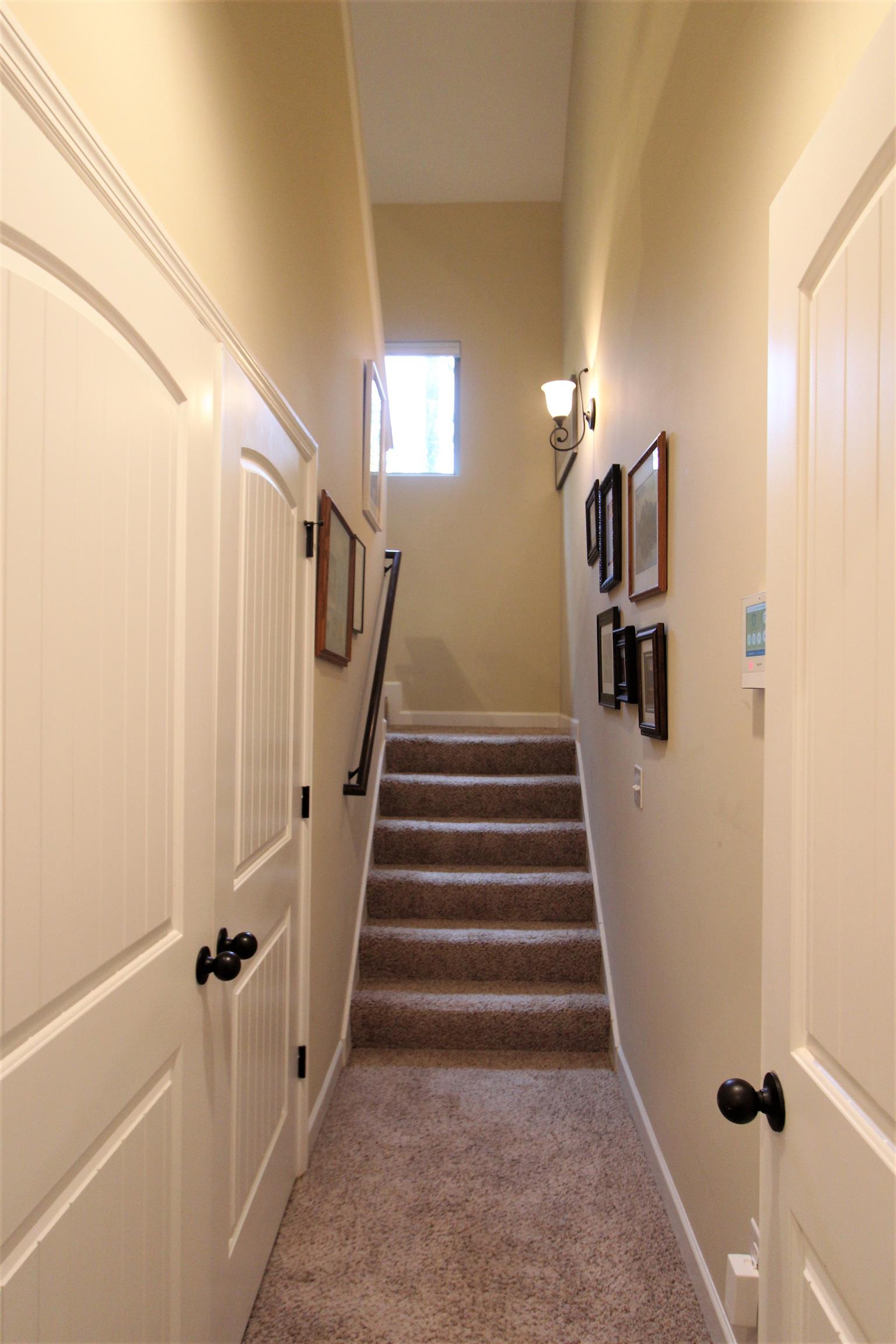 396 Abbey Road Lebanon, TN 37090 - Photo 14 of 23 a view of staircase with lots of frames on wall and wooden floor