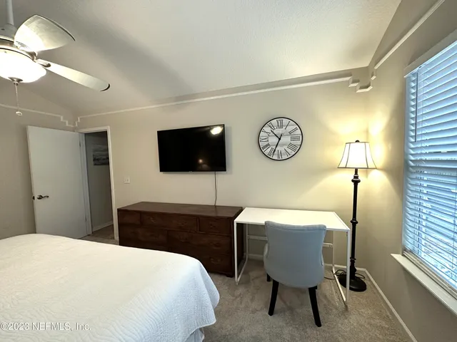 a bedroom with a bed and a table in it