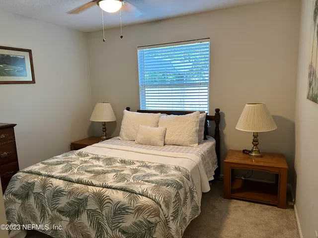 a bedroom with bed and a chandelier