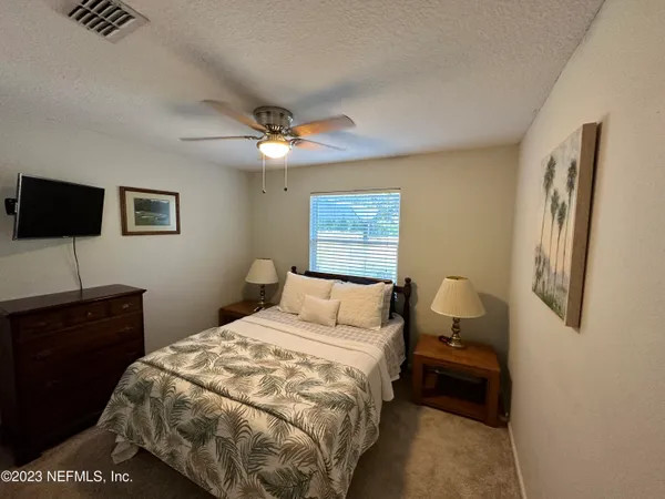 a bedroom with a bed and a desk