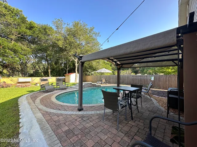 a patio with glass top table and chairs
