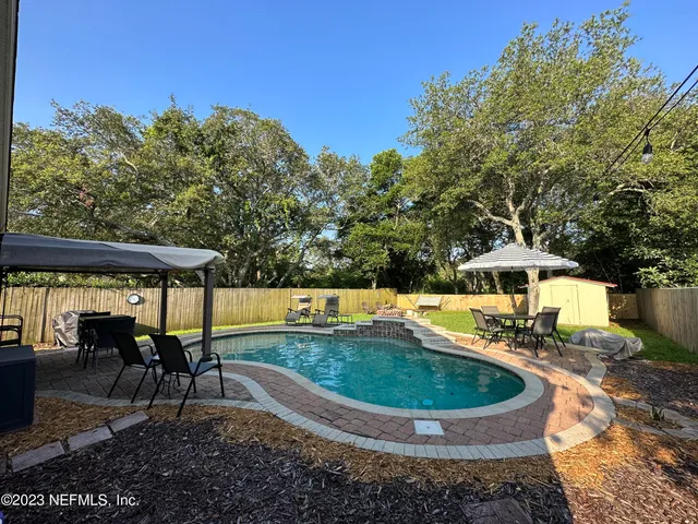 a view of a swimming pool with a patio