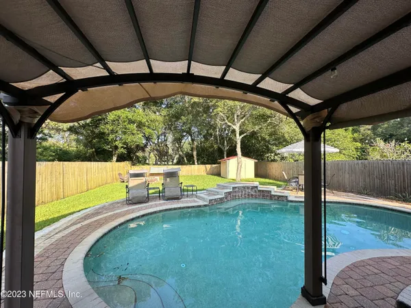 a view of a swimming pool with a porch