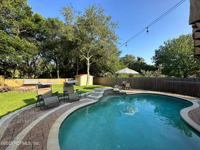 a view of a swimming pool with a patio