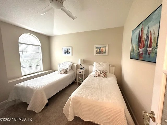 a bedroom with bed and window