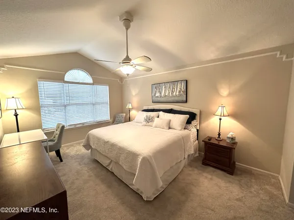 a bedroom with bed and window