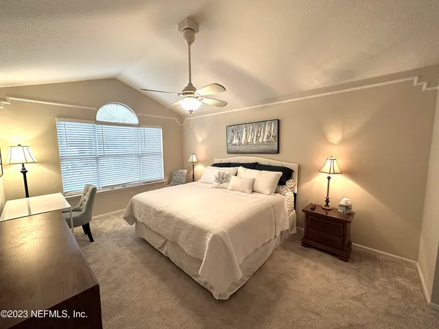 a bedroom with bed and window