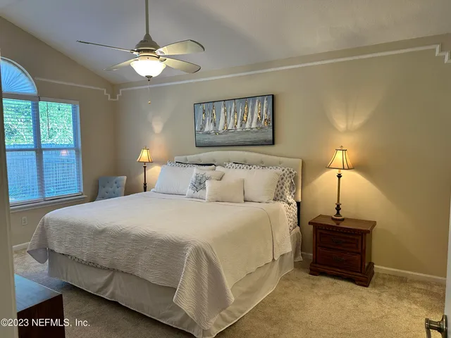 a bedroom with bed and a window