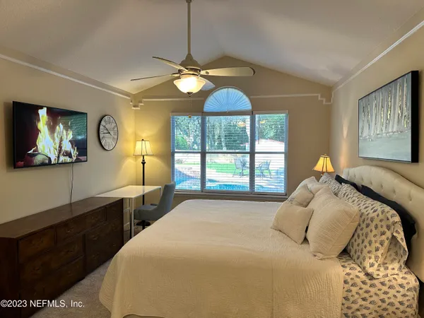 a bedroom with a bed and a chandelier