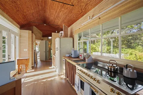 a open kitchen with stainless steel appliances granite countertop a stove a sink and a microwave