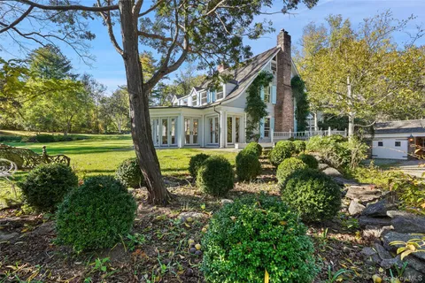 a view of yard with swimming pool and green space