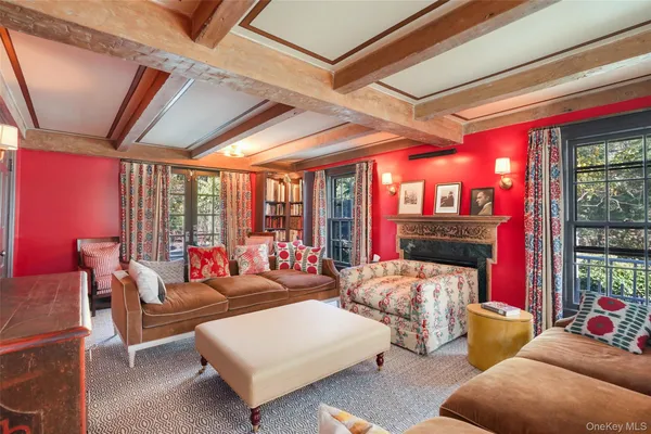 a living room with furniture a large window and a rug