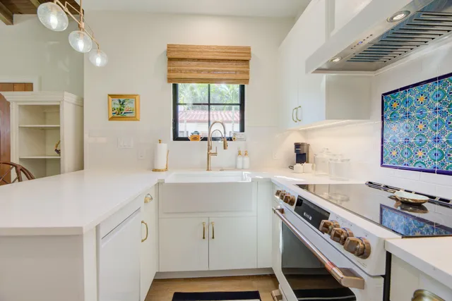 a kitchen with a sink stove and cabinets